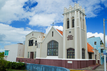 Fototapeta premium Traditional Church Architecture Under a Cloudy Blue Sky San Juan, Puerto Rico 