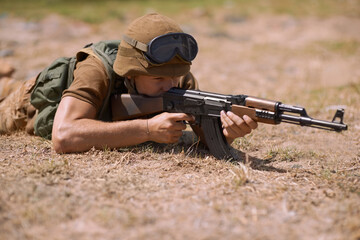Military, sniper and shooting with man and gun in nature for war, conflict and patriotism. Army,...