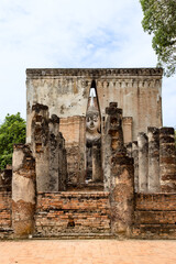 Close up of Buddha statue through the entrance gate at Sri Chum temple in Sukhothai Historic Park, a destination of tourist in Thailand