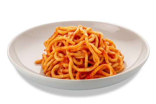 Square spaghetti, called spaghetti alla chitarra in Italy, pasta topped with red tomato sauce in a white plate isolated