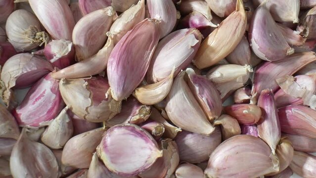 Explore the mesmerizing world of garlic up close in macro video. Witness the delicate textures and patterns that make garlic a culinary gem. Food stock footage. 4K.
