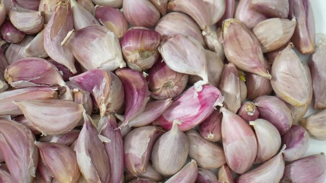 A macro video, explore the world of garlic as never before. Discover its layers, shapes, and aromas through immersive close-ups. Food stock footage. 4K.
