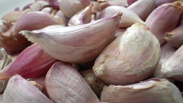 Experience the elegance of garlic like never before. Macro video showcases the allure of its curves and patterns in breathtaking detail. Food stock footage.
