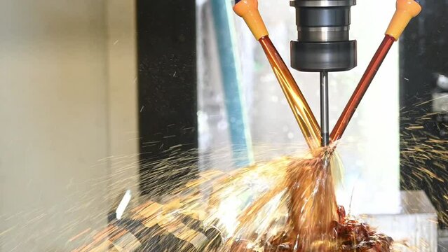 The CNC milling machine cutting the shell mold parts with oil coolant method .