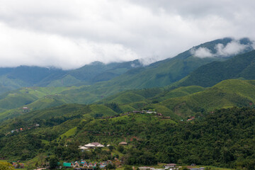 Naklejka na ściany i meble Wide angel shot of Sapan Village with fog cloud over the mountain in Nan, a tourist destination with a village in Nan province, Northern of Thailand