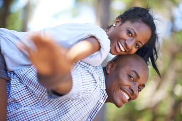 Piggyback, portrait or happy black couple in park to relax or bond on holiday vacation together to...