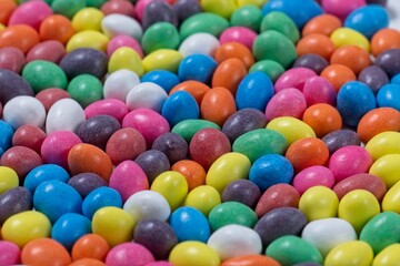Fototapeta na wymiar Close up of many colored chocolate coated peanuts selective focus