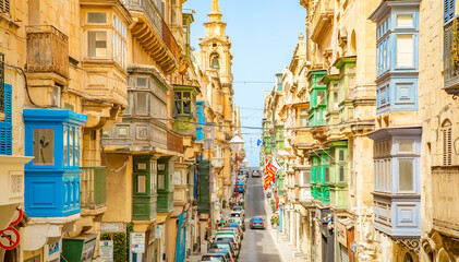 Narrow street with colorful balconies in Valletta old town, Malta