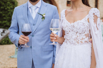 bride and groom holding glasses of wine