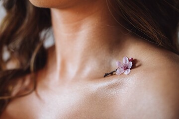 close up of a woman with a small flower