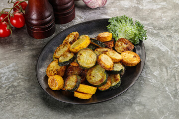 Roasted young zucchini in the plate