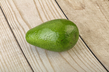 Ripe green avocado over background