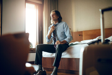 Businessman getting ready in a hotel room