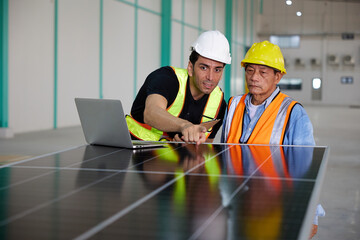 workers or technicians looking and checking solar panel in the factory