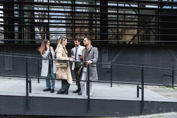 Group of young business people product strategy experts waiting for staff meeting with employer from human resources for job search in front of office building. Businessmen and businesswomen discuss