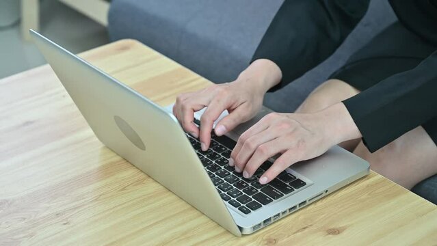 Footage of businesswoman hands while working and typing on laptop computer.