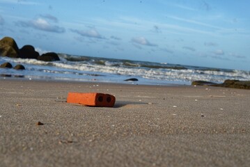 a brick on the beach in the morning