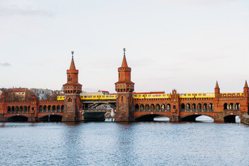 Fototapeta na wymiar yellow subway train crossing oberbaum Bridge in Berlin, Germany 