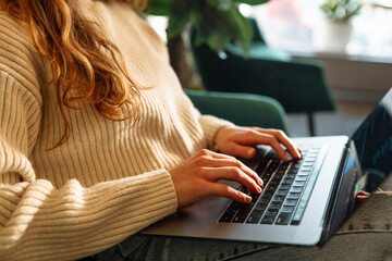 Close-up of hands working on a laptop keyboard. Freelance, online course. Technology.  Cyber...