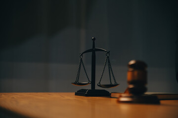 Judge gavel with Justice lawyers having team meeting at law firm background. Concepts of Law and Legal services.