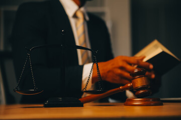 Judge gavel with Justice lawyers having team meeting at law firm background. Concepts of Law and...