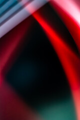 Unusual refraction of light, blurry waves and bokeh, abstract background in red, black, white colors with a gradient. Vertical banner. Copy space. Background