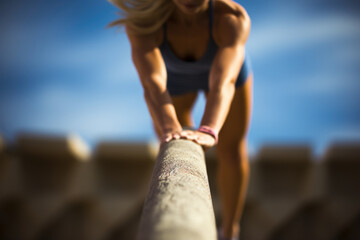 Focused athlete on a balance beam with blurred background.