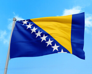 Bosnia and Herzegovina flag fluttering in the wind on sky.