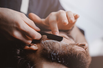 Shave with razor in barbershop, Man hipster in barber shop