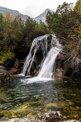 Vertical image of mountain waterfall hidden in the forest, Rila mountain