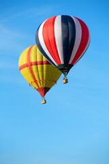 Colorful hot air balloon against the blue sky. Balloon flight.