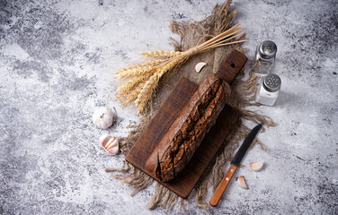 Rye bread with garlic sprinkled on a board