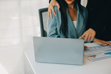 Sexsual harassment in workplace. Unhappy female employee looking at hand of boss touch at her shoulder and feeling disgusted.