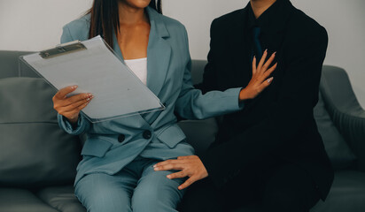 Sexsual harassment in workplace. Unhappy female employee looking at hand of boss touch at her shoulder and feeling disgusted. - obrazy, fototapety, plakaty