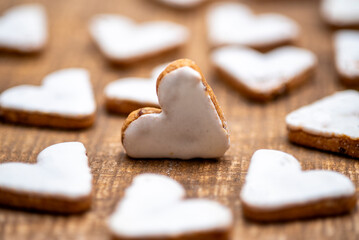 Heart-shaped cinnamon cookies, cookies with white cinnamon icing, arranged

