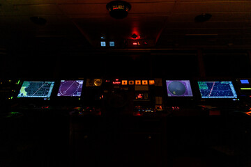 Navigational bridge on big cargo ship. Wheelhouse on vessel. ECDIS, radar. Night time. © Alexey Seafarer