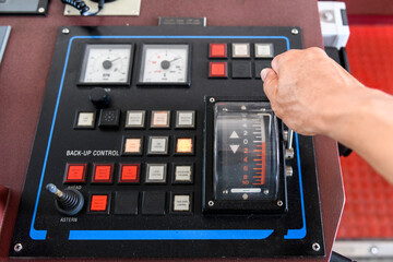 Navigational control panel with hand. Ship engine control. Navigational bridge.