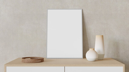 White blank poster with frame on light wall and desk with vases