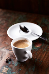 Cup of coffee on wooden background. Close up.