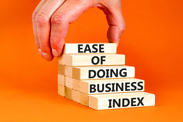 Ease of doing business index symbol. Concept words Ease of doing business index on wooden blocks. Beautiful orange table orange background. Business, ease of doing business index concept. Copy space.