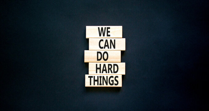 We can do hard things symbol. Concept words We can do hard things on wooden blocks. Beautiful black table black background. Business, we can do hard things concept. Copy space.