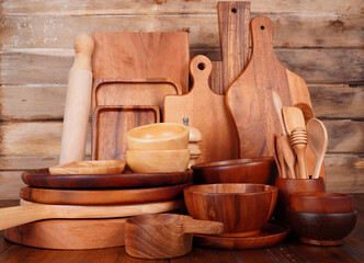 Fototapeta na wymiar Plates, cups, cutting boards, and spoons made from wood. Household appliances on a wooden table