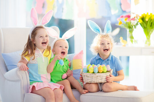 Kids on Easter egg hunt. Children dye eggs.