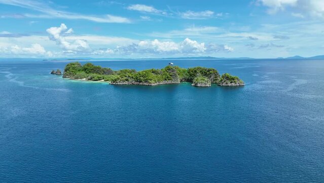Rufas Island is fringed by beautiful coral reefs in Raja Ampat, Indonesia. This region is known for its exquisite coral reefs and overall high marine biodiversity.