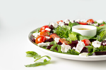salad of beets, spinach, feta cheese, olive oil, copy space, close-up