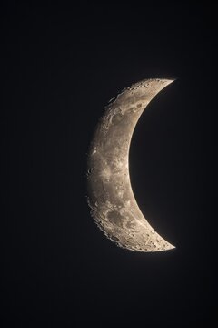 A half moon is visible in the dark sky. This image can be used to depict nighttime, astronomy, or mystery