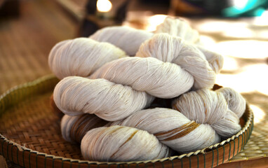 Close up image of tie a yarn of cotton in round threshing bamboo basket. Raw materials prepared for...