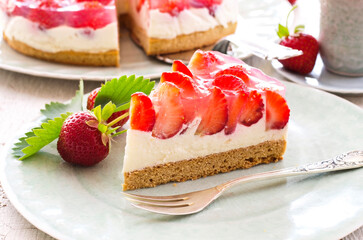 Traditional German strawberry cheese cake piece with fresh fruits served as close-up on a cake plate