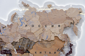 Wooden map of Russia and neighboring countries, names of countries in Russian. Map for trip planning.