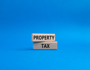 Property Tax symbol. Concept word Property Tax on wooden blocks. Beautiful blue background. Business and Property Tax concept. Copy space